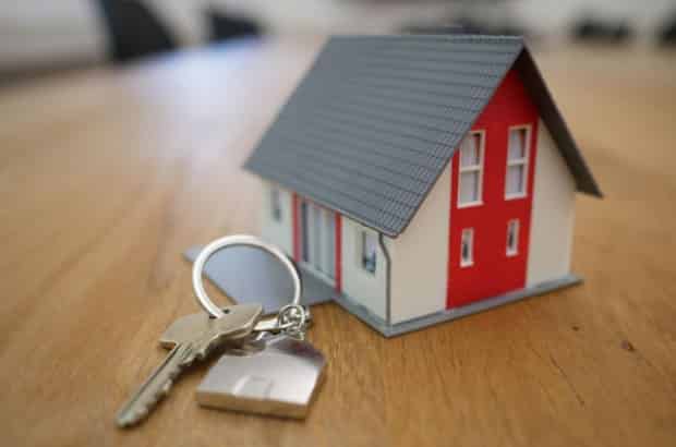 a keychain with a key and a small house